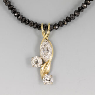 Pendant, Diamonds supplied: Marquis .67ct, (2) rounds 3.6mm, 4.05mm, Floral design 18KY, 14KW
